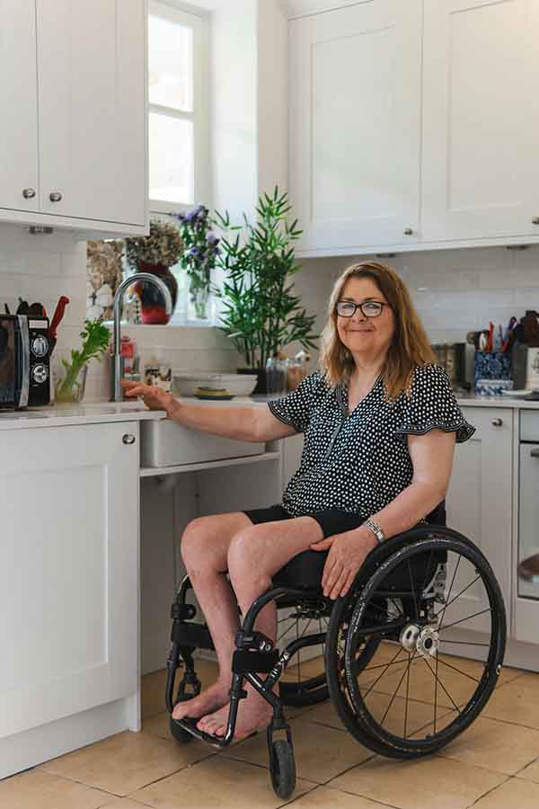 A lady in wheel chair in her kitchen